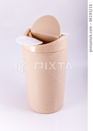 Plastic beige trash bin isolated on white background Plastic beige trash bin isolated on white background 86193218