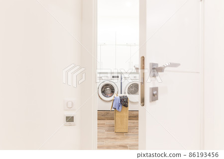 View through door to laundry room with basket and washing machine View through door to laundry room with basket and washing machine 86193456