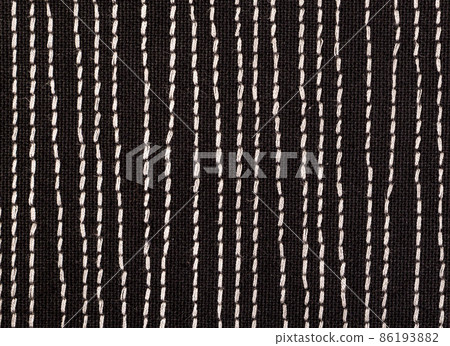Black fabrick with white stitches background texture 86193882