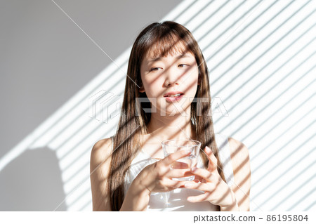 Young woman with a cup Young woman with a cup 86195804