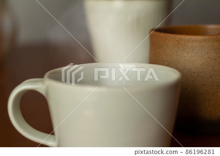 A cup of hot drink on the table A cup of hot drink on the table 86196281