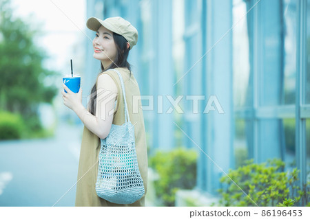 Women walking while drinking iced coffee 86196453