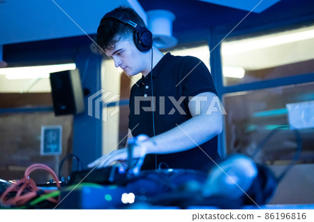 Deejay mixing at party 86196816
