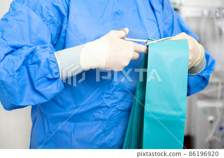 Coronavirus concept. Female nurse puts on protective cloths. Nurse wearing Personal protective Coronavirus concept. Female nurse puts on protective cloths. Nurse wearing Personal protective 86196920