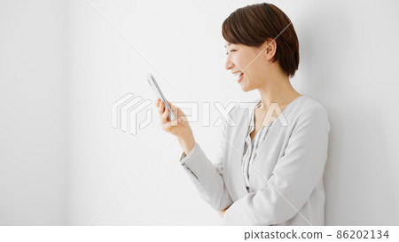 Young woman using a smartphone Young woman using a smartphone 86202134