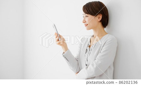 Young woman using a smartphone Young woman using a smartphone 86202136