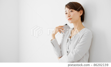 Young woman using a smartphone Young woman using a smartphone 86202139