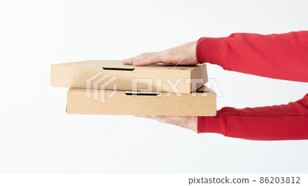 Courier hands holding cardboard pizza boxes over white background. 86203812