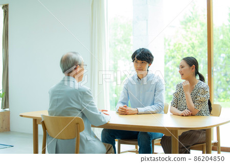 Senior man and young couple talking 86204850