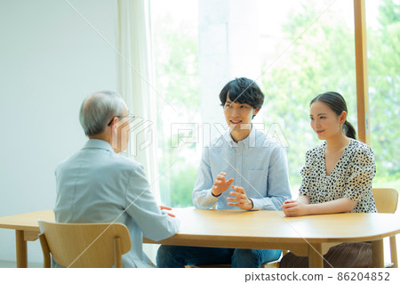 Senior man and young couple talking 86204852