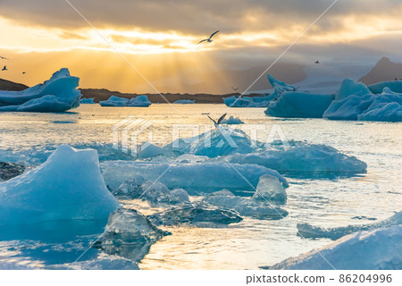 Ice Lagoon. Icebergs in Jokulsarlon glacier lagoon lake at sunset Iceland Ice Lagoon. Icebergs in Jokulsarlon glacier lagoon lake at sunset Iceland 86204996