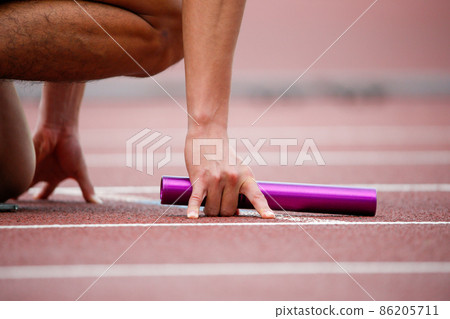 Hands that grab the baton at the start of athletics and relays 86205711