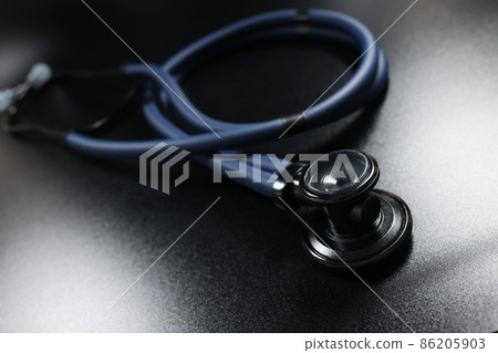 Doctor stethoscope equipment on dark surface, tool for patient diagnostic Doctor stethoscope equipment on dark surface, tool for patient diagnostic 86205903