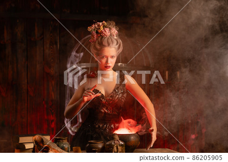 Witch with cauldron conjuring magic spell Witch with cauldron conjuring magic spell 86205905