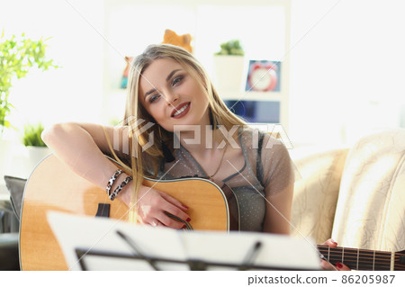 Inspired pretty woman music composer, blonde girl play on guitar Inspired pretty woman music composer, blonde girl play on guitar 86205987