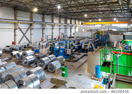 Photo of roll of painted galvanized steel sheet at cutting machine, ironworks and metalwork in 86206456