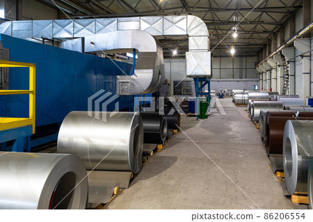 Photo of steel roofing forming machine. Industrial machine for metal sheet roof coils cut. Factory 86206554