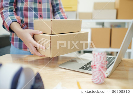 Online business owner preparing product to customer. 86208810