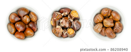 Unshelled, roasted and boiled chestnuts, in white bowls. European sweet chestnuts, Castanea sativa, can be eaten raw, candied, cooked, milled into flour, or roasted and sold as warm snack on streets. 86208940