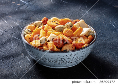 Japanese rice crackers in a bowl on a black background Japanese rice crackers in a bowl on a black background 86209372