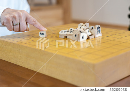 Senior woman playing shogi mountain scraps 86209988