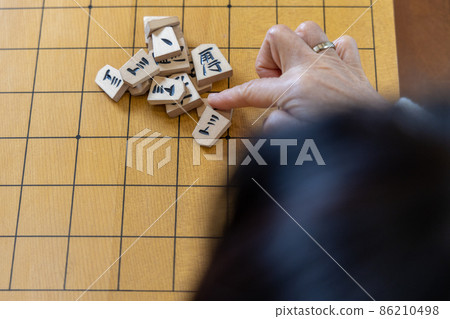 Senior woman playing shogi mountain scraps 86210498