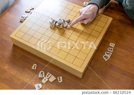 Senior woman playing shogi mountain scraps Senior woman playing shogi mountain scraps 86210524