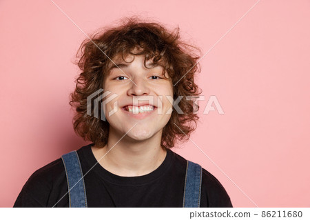 Closeup young handsome man, student in black t-shirt isolated on pink background. Concept of emotions, facial expression, youth, aspiration, sales Closeup young handsome man, student in black t-shirt isolated on pink background. Concept of emotions, facial expression, youth, aspiration, sales 86211680