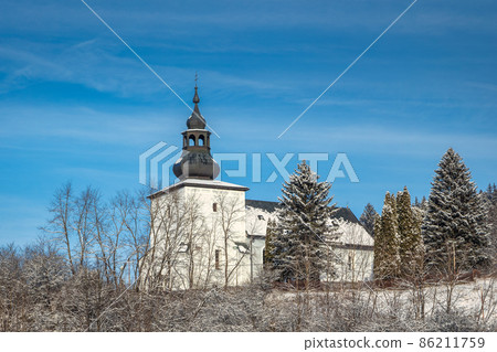 View of church in snowy winter landscape. View of church in snowy winter landscape. 86211759