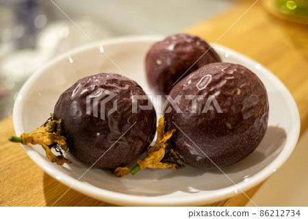 Passion fruit fruit with wrinkled skin that is ripe and ready to eat Passion fruit fruit with wrinkled skin that is ripe and ready to eat 86212734