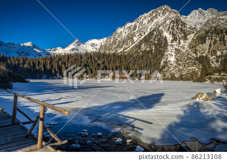 Mountain landscape with frozen tarn at winter season. Mountain landscape with frozen tarn at winter season. 86213108