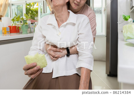 Asian senior woman with bread stuck in her throat,caregiver helping elderly people suffering from choking or food obstruction in the trachea in causing suffocation,emergency first aid,life saving Asian senior woman with bread stuck in her throat,caregiver helping elderly people suffering from choking or food obstruction in the trachea in causing suffocation,emergency first aid,life saving 86214384