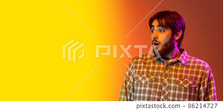Cropped portrait of young man with shocked, surprised face posing isolated over gradient pink yellow background. Flyer Cropped portrait of young man with shocked, surprised face posing isolated over gradient pink yellow background. Flyer 86214727