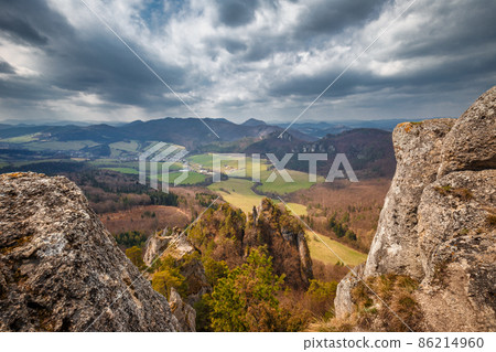 View of the mountainous landscape with rock formations in partly View of the mountainous landscape with rock formations in partly 86214960