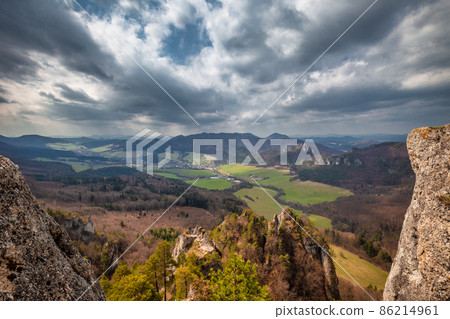 View of the mountainous landscape with rock formations in partly View of the mountainous landscape with rock formations in partly 86214961