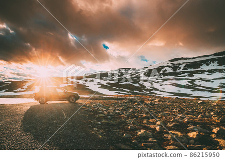 Aurlandsfjellet, Norway. Car SUV Parked Near Aurlandsfjellet Scenic Route Road In Summer Norwegian Landscape. Popular Destination In Sunset Lights 86215950
