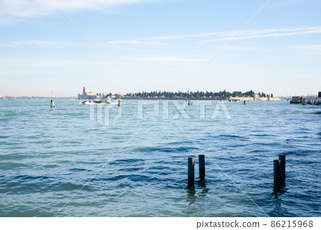Venice typical landscape. Boat floating on canal. Italian landmark. Venice typical landscape. Boat floating on canal. Italian landmark. 86215968
