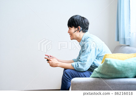 Men playing games at home Men playing games at home 86216018