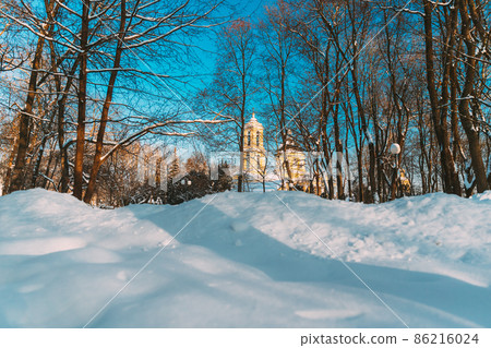 Gomel, Belarus. Winter City Park. Peter And Paul Cathedral In Sunny Winter Day. Famous Local Landmark In Snow Gomel, Belarus. Winter City Park. Peter And Paul Cathedral In Sunny Winter Day. Famous Local Landmark In Snow 86216024