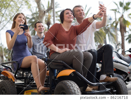 family of tourists enjoy a walk on the bike carriage family of tourists enjoy a walk on the bike carriage 86216718