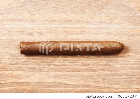 cigar on wooden background cigar on wooden background 86217237