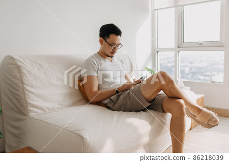 Middle age man with long eye sight try to look at the smartphone. 86218039