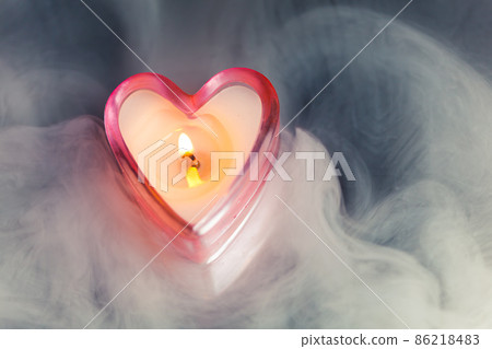 burning candle heart in dense fog 86218483