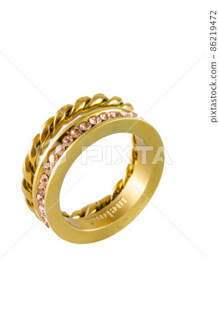 Knotted sparkly twin golden ring with zircons isolated on white background. Beautiful valentine's gift. 86219472