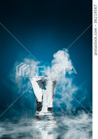 shot glass of vodka with ice vapor 86219567