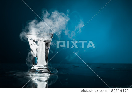 shot glass of vodka with ice vapor 86219571