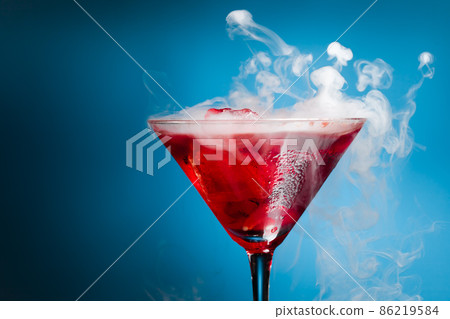 red cocktail with ice vapor 86219584