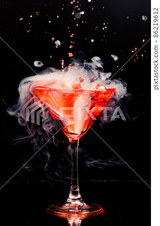 red cocktail with splash and ice vapor 86219612