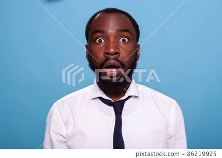 Shocked businessman looking surprised with open mouth facing unbelievable situation Shocked businessman looking surprised with open mouth facing unbelievable situation 86219925