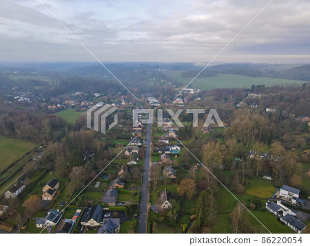 Aerial view of houses surrounded by forest in the country side area of Walloon, Belgium 86220054